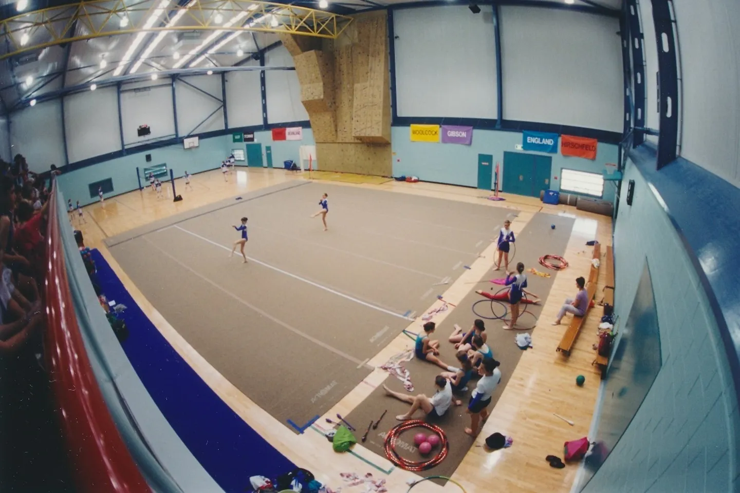 1996 Volleyball and Rhythmic Gymnastics share the gym space with the climbing wall